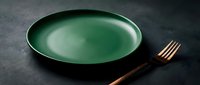 Green ceramic bowl with wooden fork on dark textured surface, ready for food styling, restaurant design, culinary content, and dining concepts.