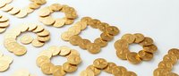 Golden coins arranged in circular and square patterns on white background, symbolizing wealth, savings, investment, and financial success for business and banking concepts.