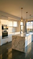 Modern luxury kitchen with white cabinetry, marble island, stainless steel appliances, pendant lighting, and floor-to-ceiling windows overlooking cityscape at sunset.
