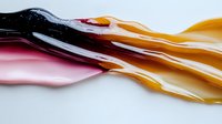 Flowing liquid paint in vibrant colors creating smooth waves and ripples on white background for modern artistic design and creative projects.
