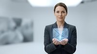 Woman in dark blazer and white shirt holding glowing digital envelope icon, representing email communication, business correspondence, and modern digital messaging technology.