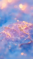 Magical golden glitter sparkles on dreamy purple and blue background with soft bokeh lights creating ethereal atmosphere for fantasy designs and celebrations.