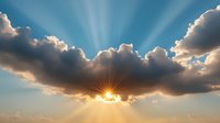 Dramatic sunburst breaking through dark clouds with divine light rays streaming down from heaven against blue sky background, creating spiritual atmosphere.