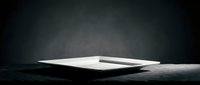 Minimalist workspace featuring an open notebook with pen on dark textured surface, ideal for business, education, and creative projects.