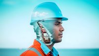 Maritime worker profile with cargo ship double exposure overlay on ocean background for industrial and shipping concepts.