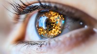 Close-up macro shot of human eye with digital technology reflection showing golden pixels and blue glow, representing artificial intelligence and future vision concept.