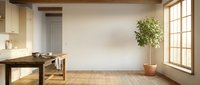 Minimalist workspace with wooden desk, chair, potted plant, and natural light from large window in empty room with beige walls.