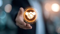 Businessman holding glowing digital handshake icon, symbolizing partnership and agreement in corporate networking environment with bokeh background.