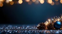 Pine cones and blue Christmas ornament on glittery surface with warm bokeh lights creating magical holiday atmosphere against dark background.