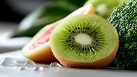 Fresh kiwi fruit halved with water droplets, displaying vibrant green flesh and black seeds. Ideal for food, nutrition, healthy eating, and culinary content.