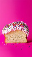 Slice of white bread topped with pink frosting and colorful sprinkles on vibrant pink background, creative food photography for bakery and dessert concepts.