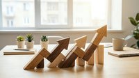 Wooden arrow blocks arranged in ascending growth pattern on modern office desk with natural lighting, symbolizing business success and upward progress.
