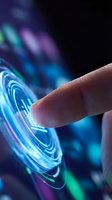 Fingertip touching glowing blue and purple holographic circular interface with concentric rings, representing digital technology, innovation, and futuristic interaction.
