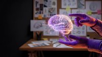 Hands holding glowing holographic brain model in modern office workspace with charts and documents on desk for medical technology presentations.