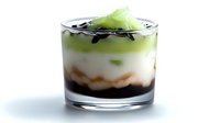 Layered green tea matcha dessert with cream and chocolate in glass cup isolated on white background for culinary design and menu presentation.