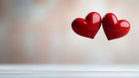 Two glossy red hearts floating against soft blurred background, symbolizing romance, love and togetherness. Romantic concept for Valentine's Day cards and anniversary designs.