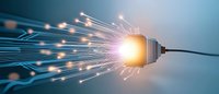 Glowing fiber optic network connection with light bursting from digital cable against blue technology background.