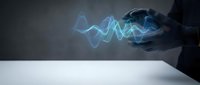 Businessman hand holding glowing blue digital sound wave energy pattern over white surface for technology and audio visualization concepts.
