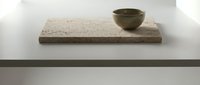 Minimalist interior design featuring a concrete shelf with a small olive green ceramic bowl, modern home decor and styling.