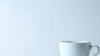 White ceramic coffee cup on clean background for morning beverage branding and cafe marketing materials.