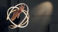 Hand holding glowing neon orb sphere with balance and control text, modern business concept for leadership, strategy, and equilibrium in corporate environments.