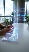 Male developer typing on glowing keyboard with holographic code and data charts floating above in modern office workspace.