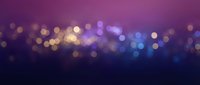 Defocused bokeh lights in purple, blue, and gold tones create an elegant abstract background suitable for presentations, websites, and festive designs.