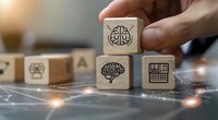 Wooden blocks with artificial intelligence and brain icons arranged on digital network surface, perfect for AI technology and machine learning concepts.