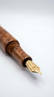 Luxury wooden fountain pen with golden nib isolated on white background for writing, calligraphy and business correspondence concepts.