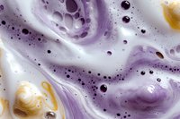 Abstract purple and gold marble swirl pattern with bubbles and foam texture for modern design backgrounds and creative projects.