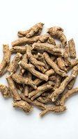 Dried ginseng root pieces scattered on white background, suitable for herbal medicine, wellness products, traditional remedies, and natural supplement packaging designs.