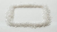 Sparkling crystal beads arranged in rounded square frame on white background, isolated design element for jewelry, crafts, and decorative projects.
