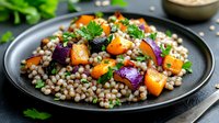 Nutritious lentil salad with roasted vegetables, fresh herbs and colorful ingredients served on dark plate for healthy meal preparation and vegetarian dining.