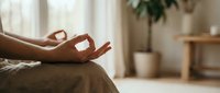 Woman practicing meditation with mudra hand gesture in peaceful home interior with natural lighting and plants creating zen atmosphere for mindfulness.