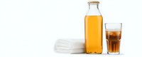 Fresh cold kombucha tea in glass bottle and drinking glass with ice cubes on white background, healthy fermented probiotic beverage with copy space.