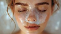 Young Caucasian woman with closed eyes and glowing freckled skin in warm sunlight, face close-up showing natural beauty, dewy complexion and peaceful expression.