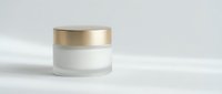 Luxury cosmetic cream jar with golden cap on white background for skincare and beauty product packaging design.