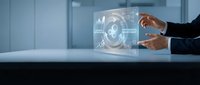 Businessman hands interacting with futuristic holographic interface displaying data analytics and digital technology in modern office environment.