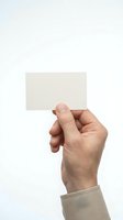 Male hand holding blank white business card mockup against neutral background for branding and corporate identity design projects.
