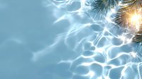 Sunlit palm leaves cast rippling reflections on crystal clear turquoise water surface, creating mesmerizing light patterns and tropical summer atmosphere.