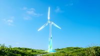 Wind turbine standing in green field under clear blue sky, generating renewable energy for sustainable power production and clean electricity generation.