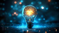 Glowing light bulb filled with golden particles and digital data against blurred blue bokeh background, representing innovation, creativity, and smart technology solutions for business and design projects.