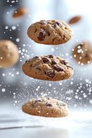 Levitating chocolate chip cookies with powdered sugar falling in motion against light background, creating magical food photography effect for bakery advertising.