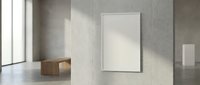 Minimalist interior with blank white frame on concrete wall, wooden bench and natural lighting for modern home or office design mockup.