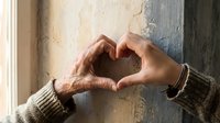 Elderly and young hands forming heart shape together by weathered window symbolizing intergenerational love, family bonds, care, support and unity.