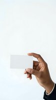 Hand holding blank white card isolated on light background, ready for custom text or branding design for business, marketing, or promotional use.
