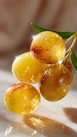 Fresh ripe yellow grapes with water drops and green leaves on light background, macro shot with selective focus and natural sparkle effect.