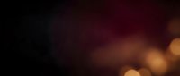 Blurred bokeh background with warm golden and amber light particles fading into dark burgundy tones, suitable for overlays and design backdrops.