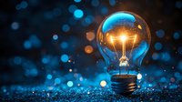 Glowing light bulb with warm filament on sparkling blue bokeh background representing innovation, creativity and bright ideas for business concepts.