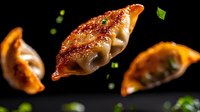 Pan-fried Asian dumplings with crispy golden crust floating in dark space, garnished with fresh green onions. Dramatic food photography with selective focus.